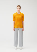 A model wears the PLEATS PLEASE ISSEY MIYAKE TWISTED BORDER SHIRT shirt.