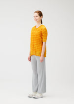 A model wears the PLEATS PLEASE ISSEY MIYAKE TWISTED BORDER SHIRT shirt.