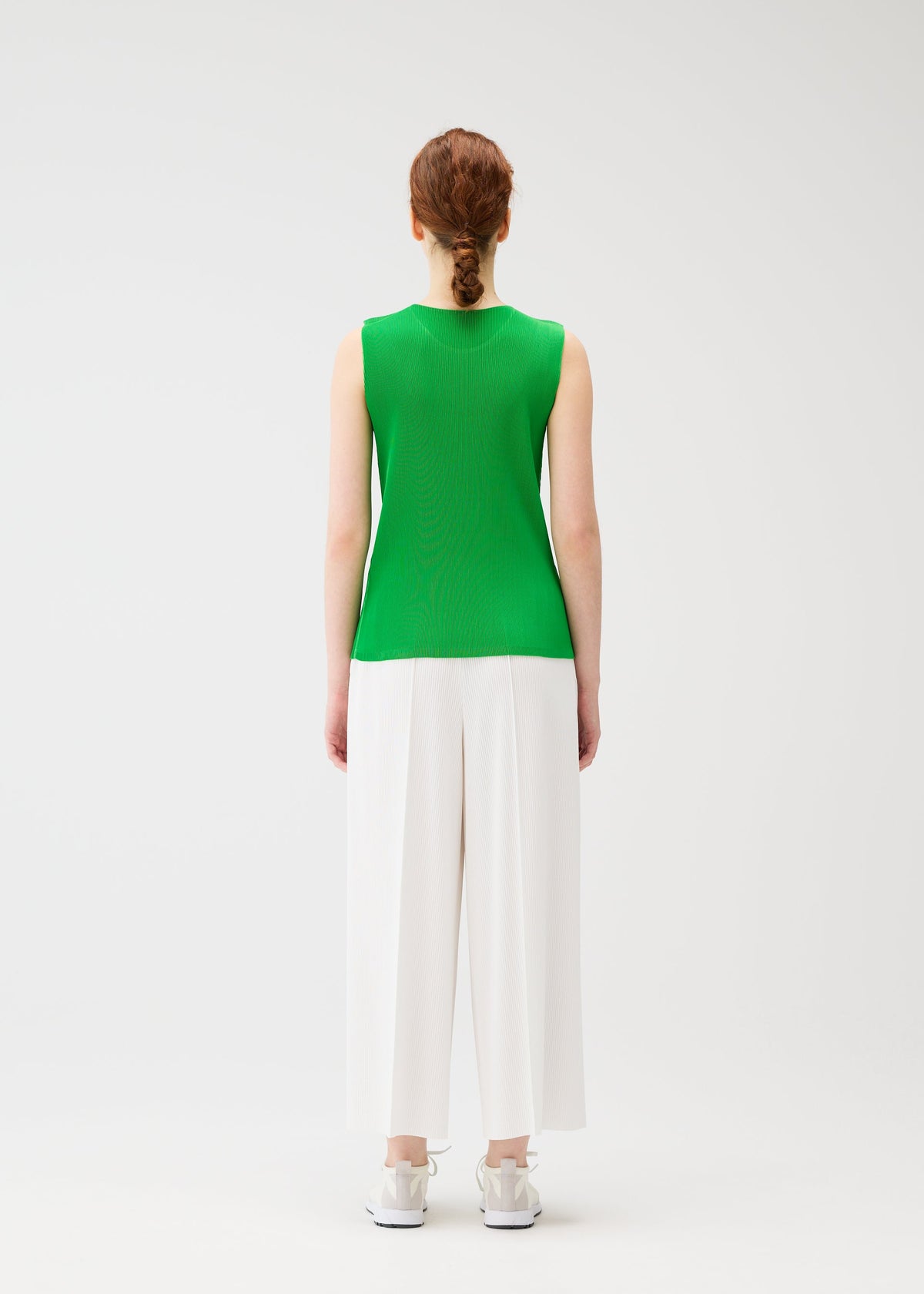 A model wears the PLEATS PLEASE ISSEY MIYAKE MIST APRIL shirt.