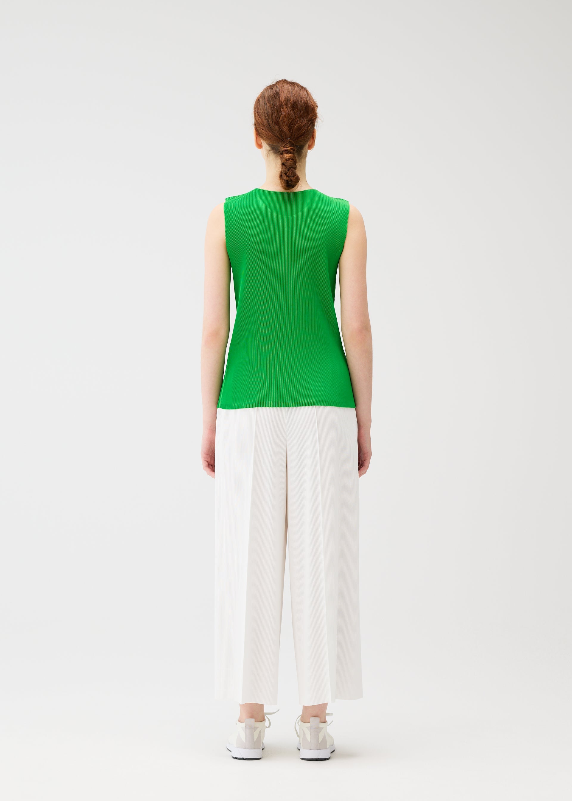 A model wears the PLEATS PLEASE ISSEY MIYAKE MIST APRIL shirt.