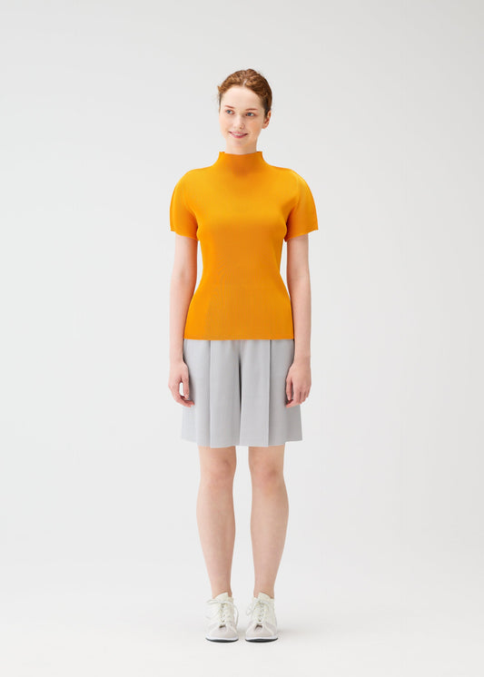 A model wears the PLEATS PLEASE ISSEY MIYAKE MIST APRIL shirt.