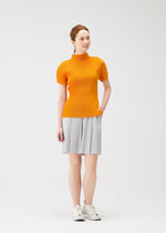 A model wears the PLEATS PLEASE ISSEY MIYAKE MIST APRIL shirt.