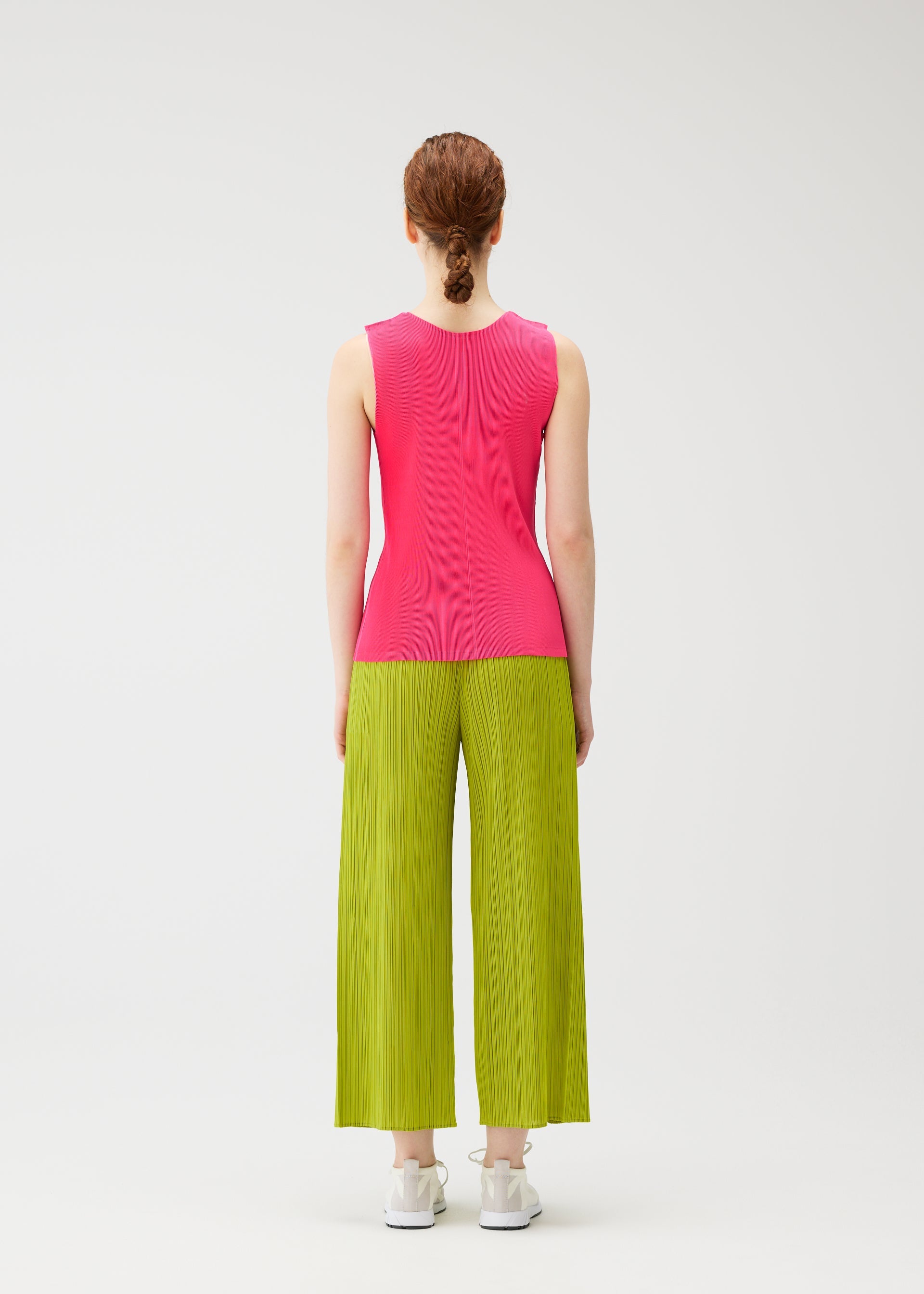 A model wears the PLEATS PLEASE ISSEY MIYAKE MIST JUNE mist-june-shirt-bright-pink.