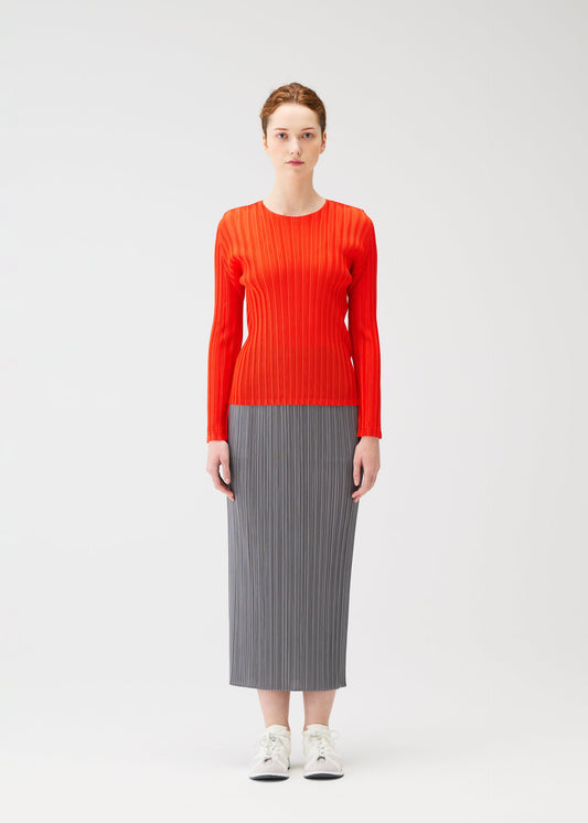 A model wears the PLEATS PLEASE ISSEY MIYAKE RIB PLEATS FEBRUARY shirt.