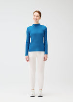 A model wears the PLEATS PLEASE ISSEY MIYAKE RIB PLEATS FEBRUARY shirt.