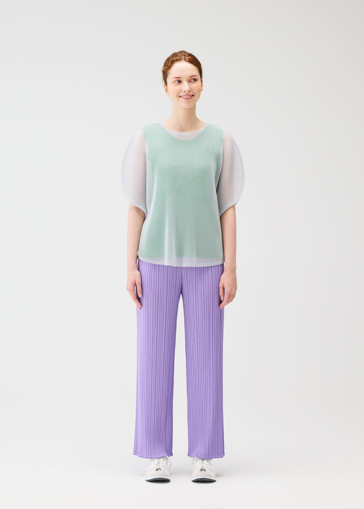 A model wears the PLEATS PLEASE ISSEY MIYAKE TATAMI APRIL shirt.