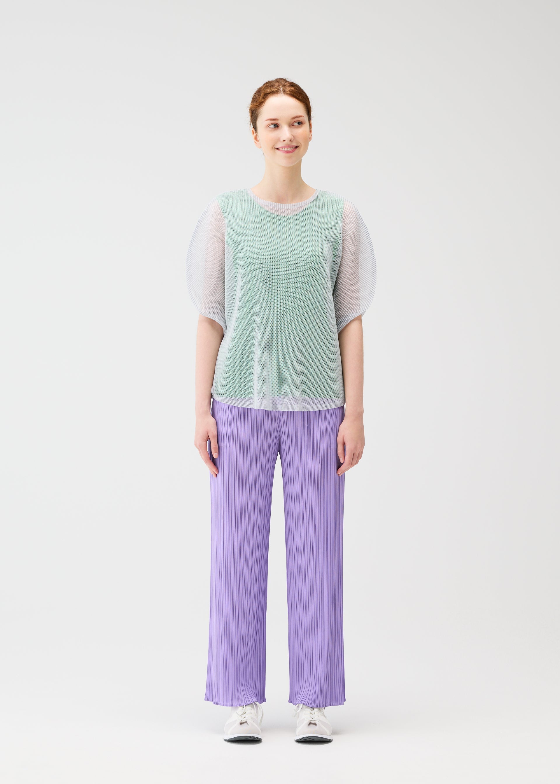 A model wears the PLEATS PLEASE ISSEY MIYAKE TATAMI APRIL shirt.
