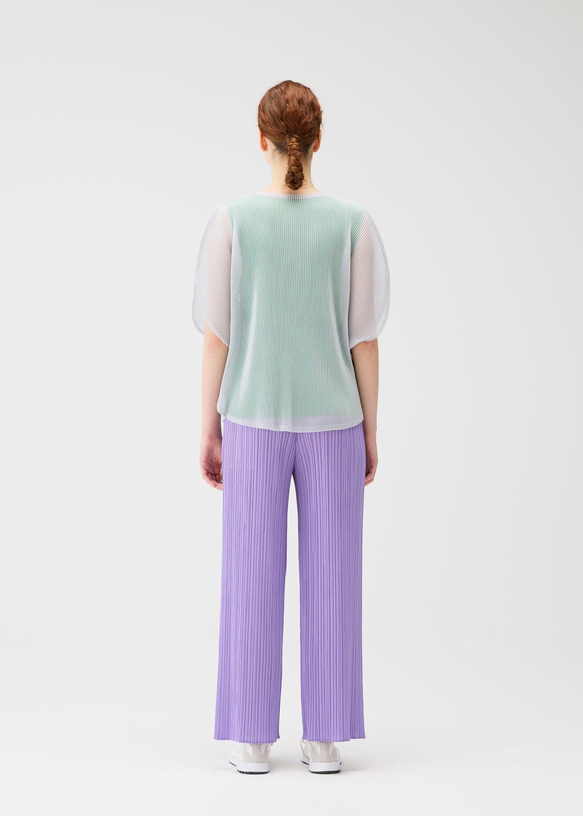 A model wears the PLEATS PLEASE ISSEY MIYAKE TATAMI APRIL shirt.