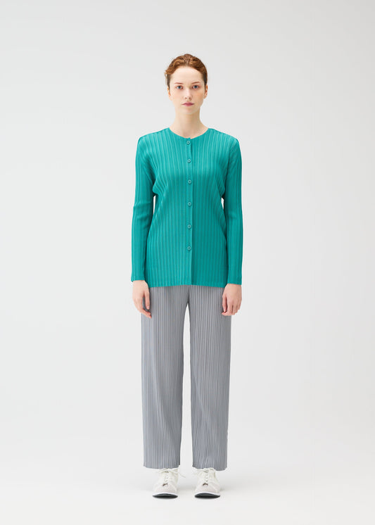 A model wears the PLEATS PLEASE ISSEY MIYAKE RIB PLEATS FEBRUARY cardigan.