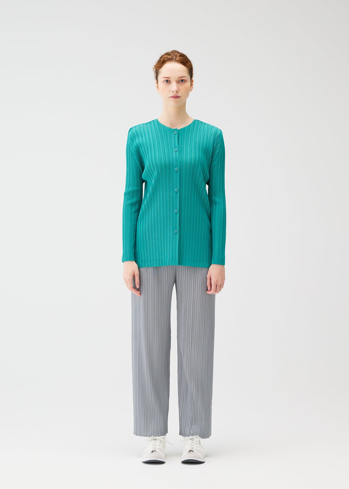 A model wears the PLEATS PLEASE ISSEY MIYAKE RIB PLEATS FEBRUARY cardigan.