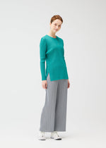 A model wears the PLEATS PLEASE ISSEY MIYAKE RIB PLEATS FEBRUARY cardigan.