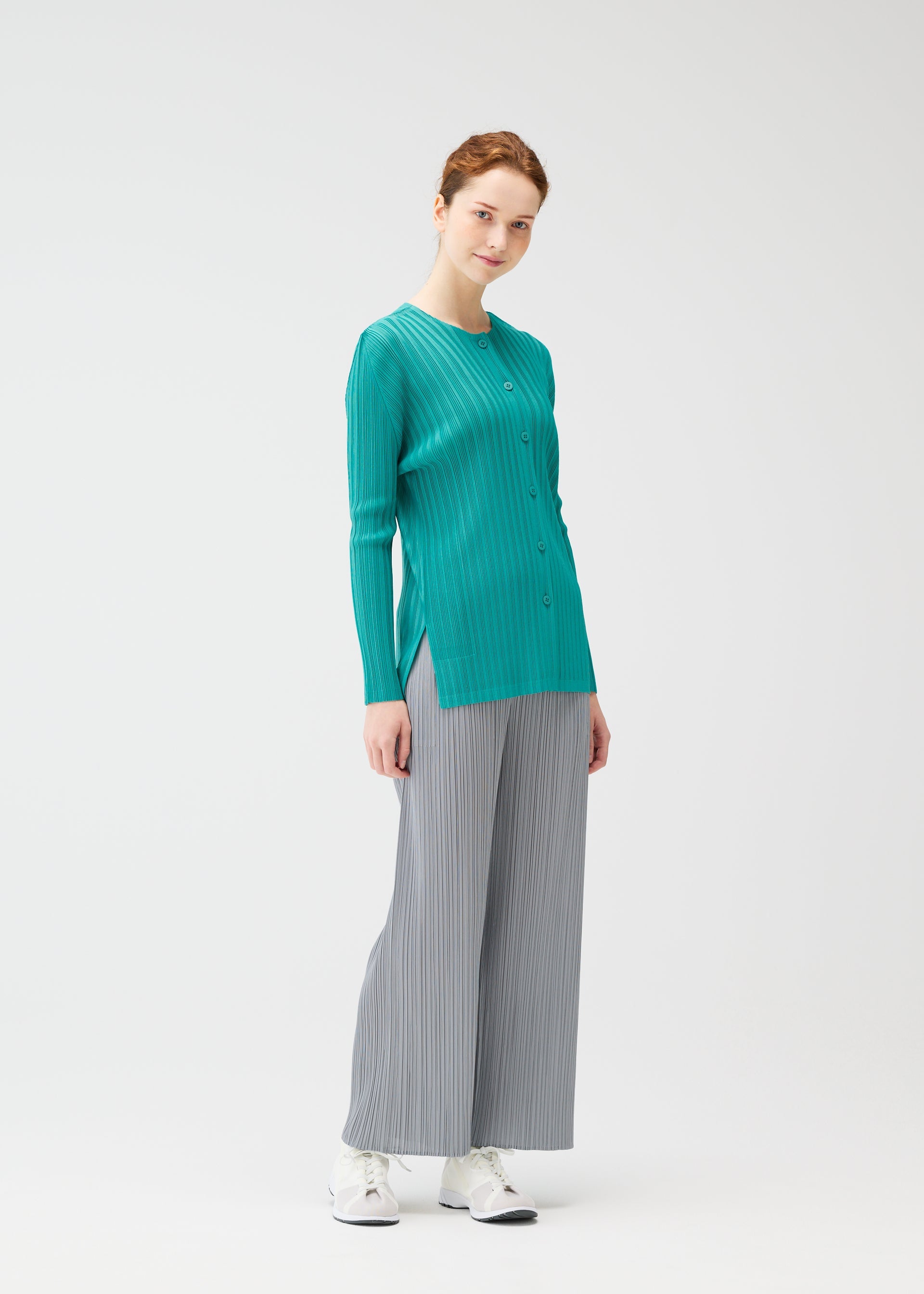 A model wears the PLEATS PLEASE ISSEY MIYAKE RIB PLEATS FEBRUARY cardigan.