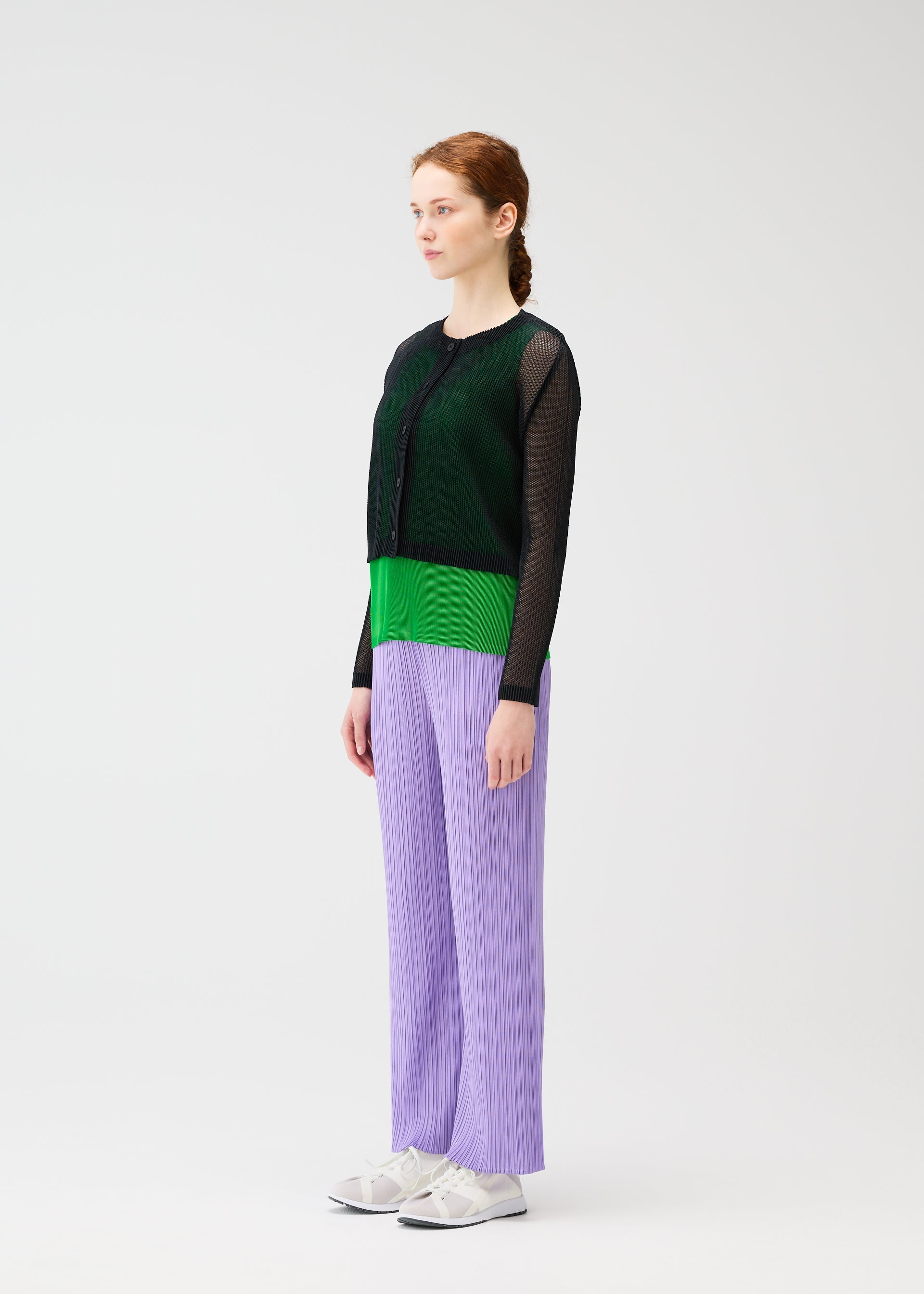 A model wears the PLEATS PLEASE ISSEY MIYAKE TATAMI APRIL cardigan.