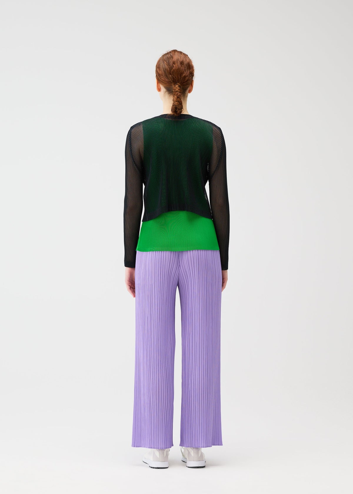 A model wears the PLEATS PLEASE ISSEY MIYAKE TATAMI APRIL cardigan.