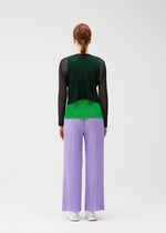A model wears the PLEATS PLEASE ISSEY MIYAKE TATAMI APRIL cardigan.