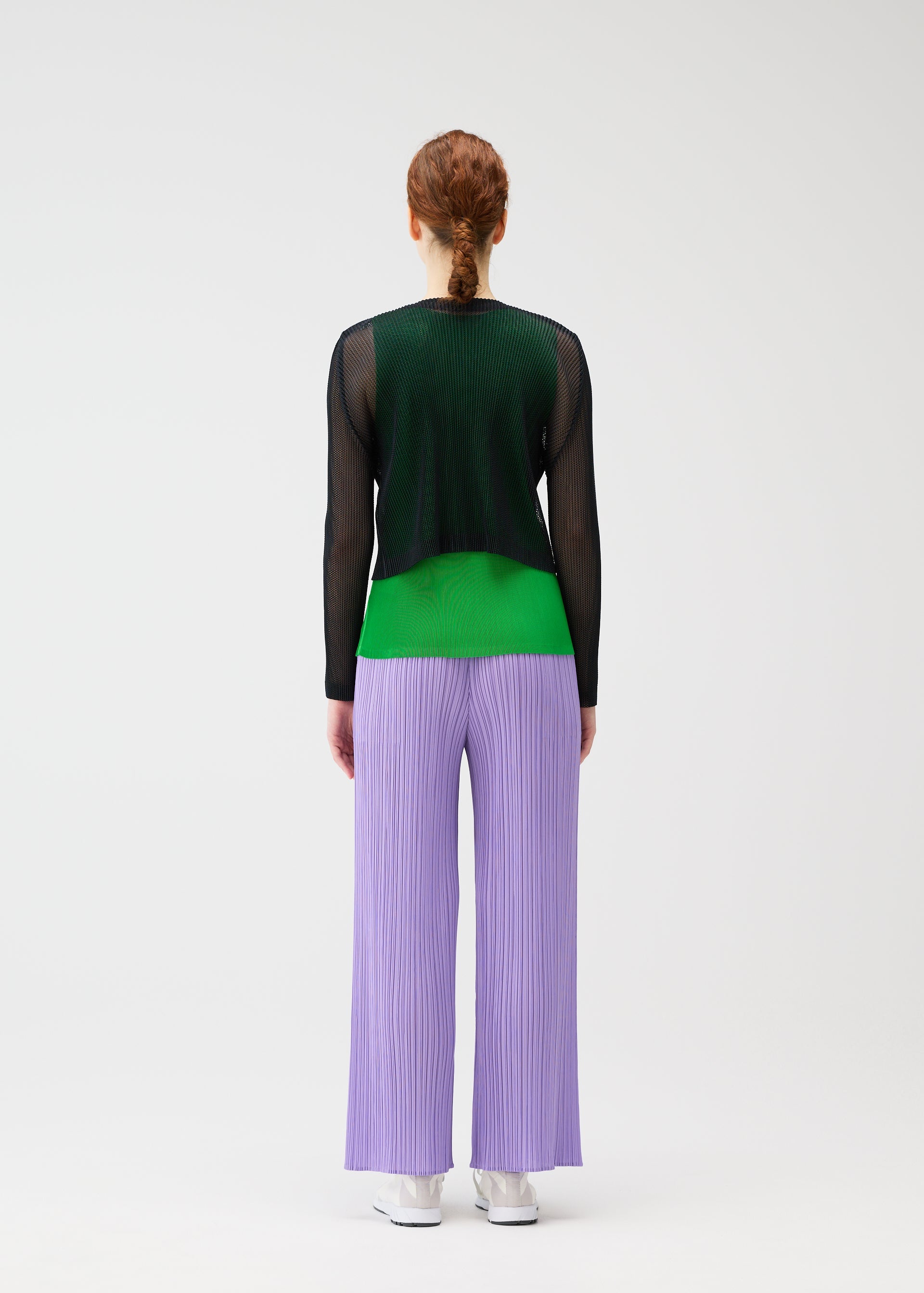 A model wears the PLEATS PLEASE ISSEY MIYAKE TATAMI APRIL cardigan.