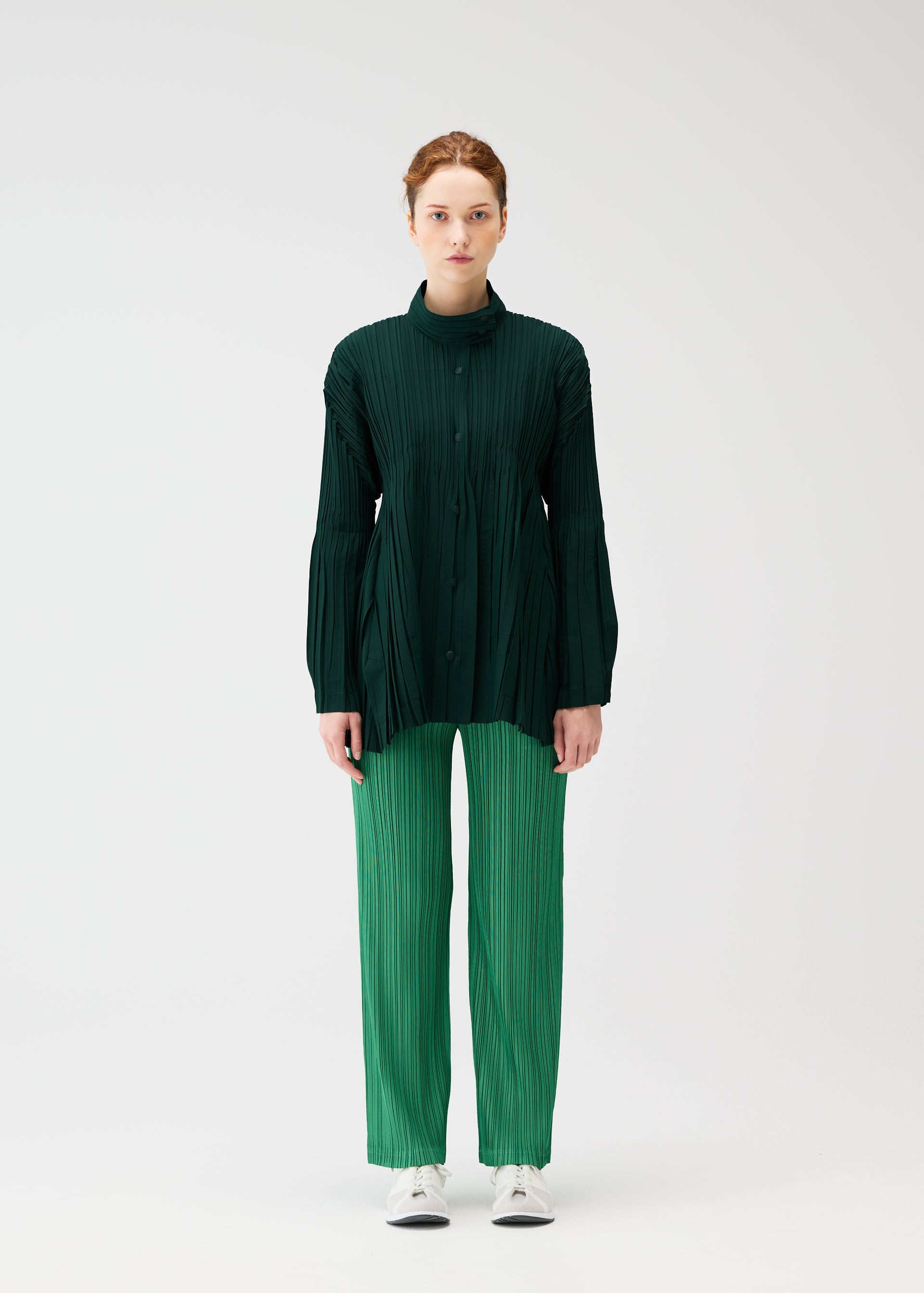 A model wears the PLEATS PLEASE ISSEY MIYAKE FLOAT COAT cardigan.