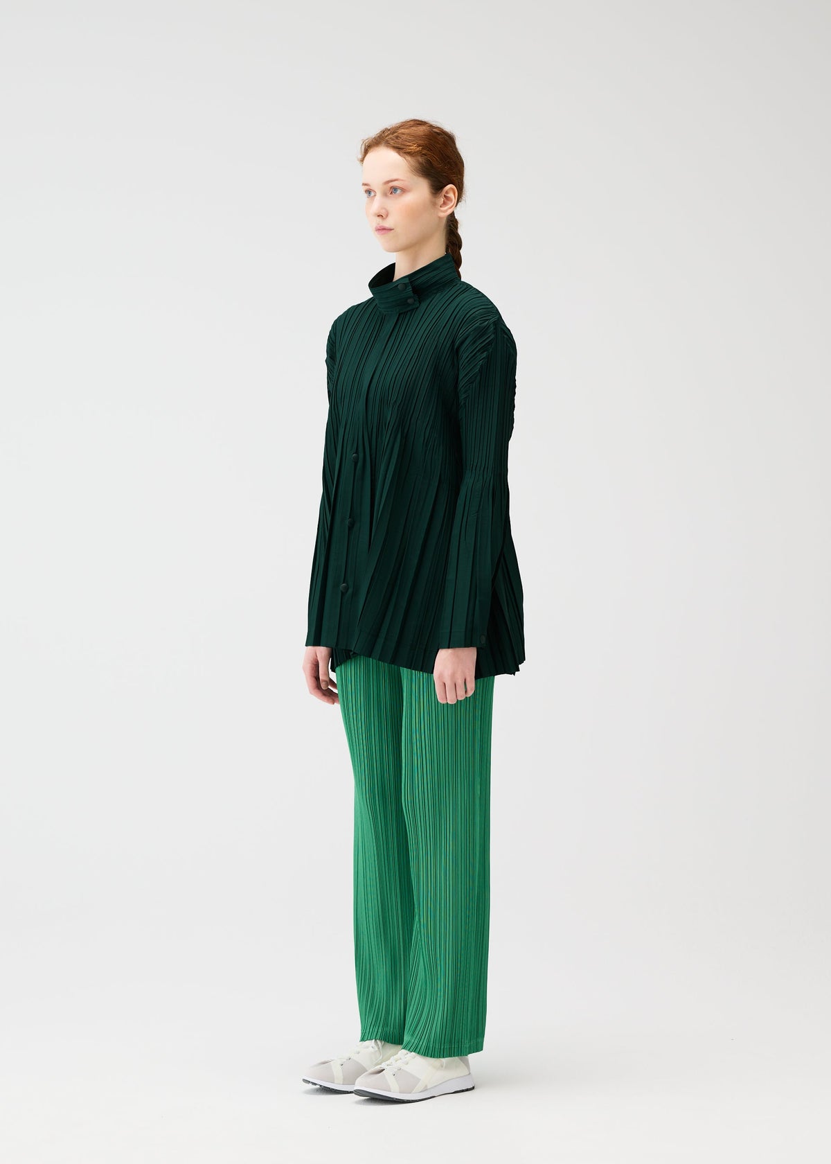A model wears the PLEATS PLEASE ISSEY MIYAKE FLOAT COAT cardigan.