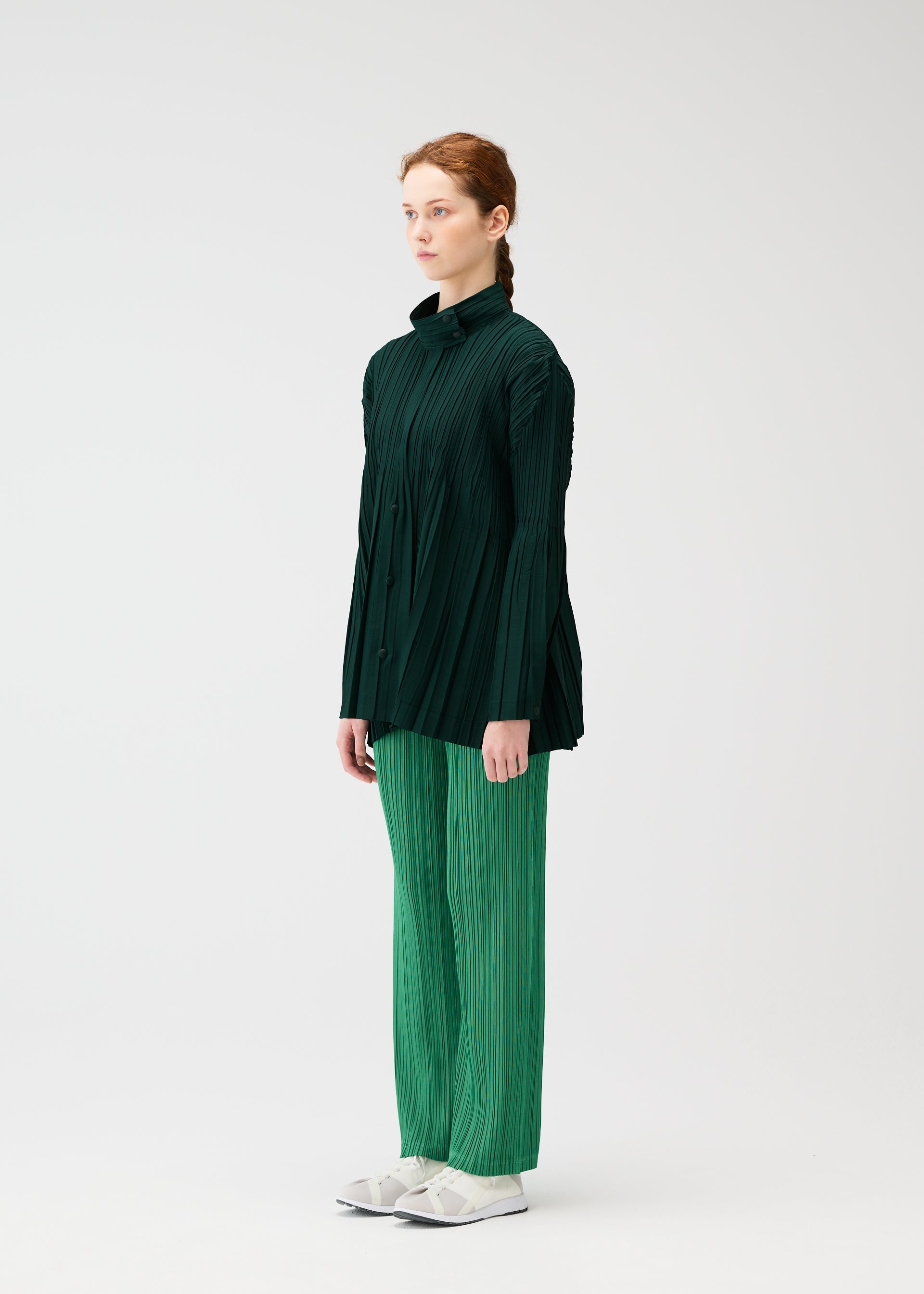 A model wears the PLEATS PLEASE ISSEY MIYAKE FLOAT COAT cardigan.