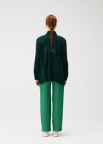 A model wears the PLEATS PLEASE ISSEY MIYAKE FLOAT COAT cardigan.