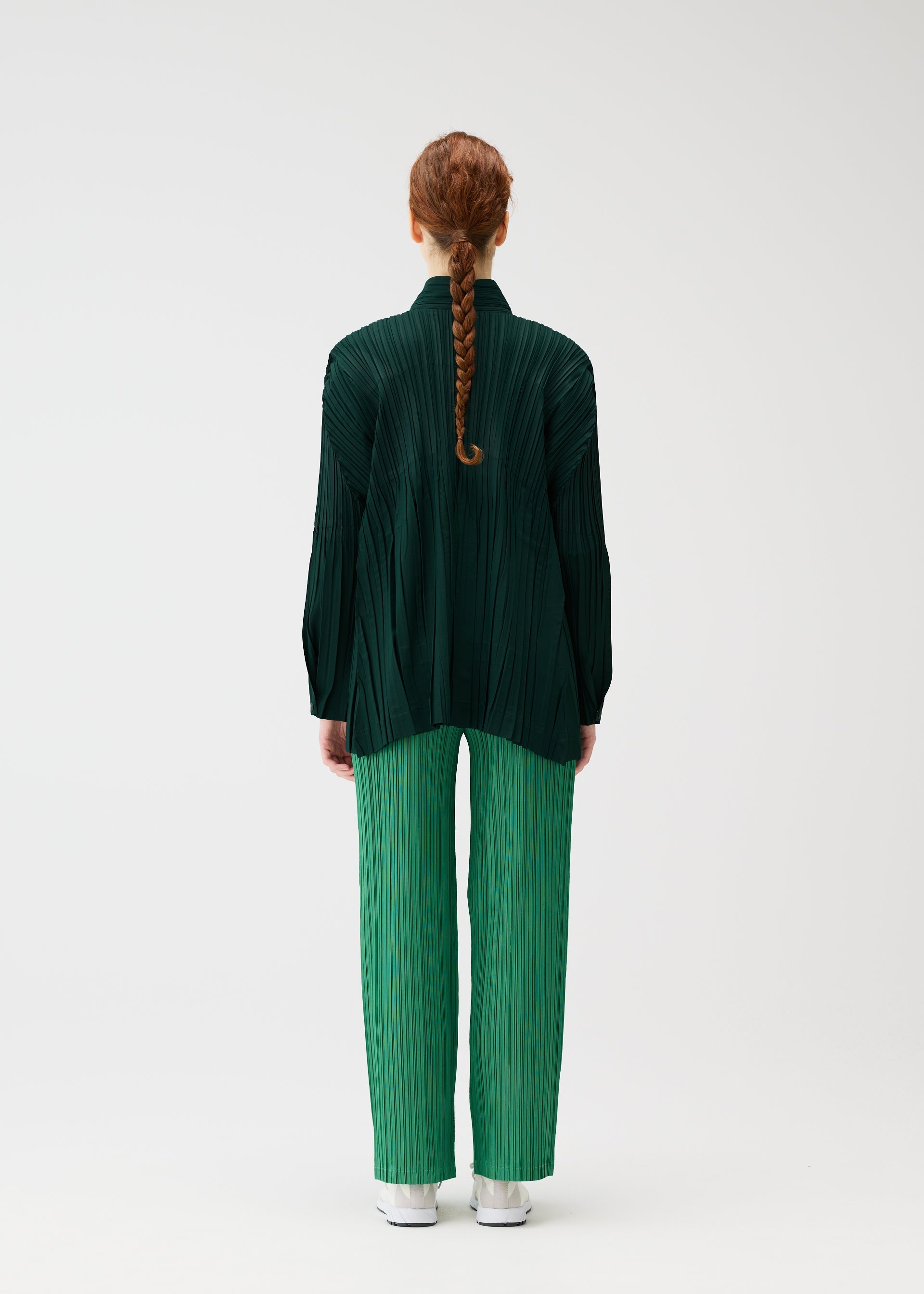 A model wears the PLEATS PLEASE ISSEY MIYAKE FLOAT COAT cardigan.
