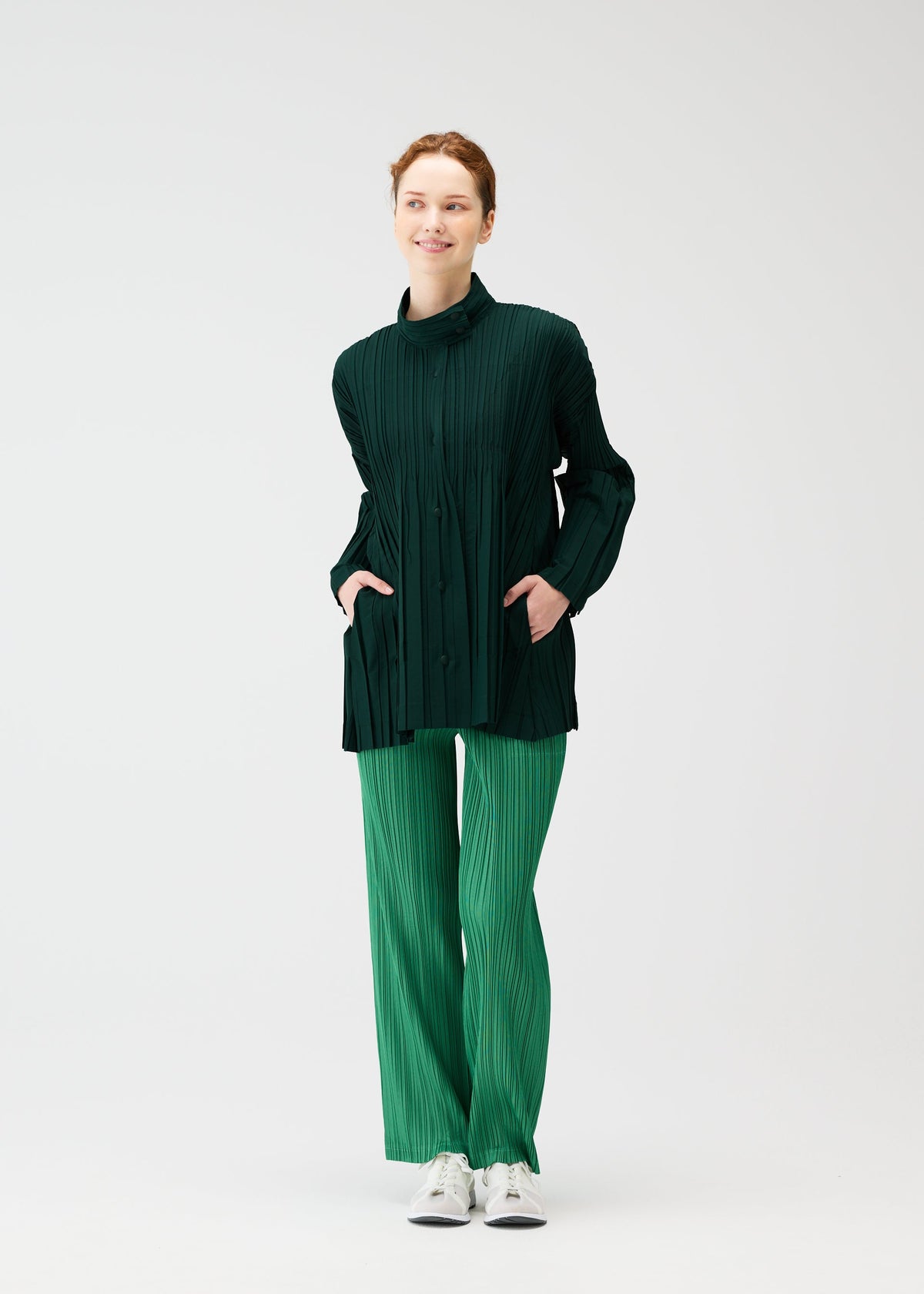 A model wears the PLEATS PLEASE ISSEY MIYAKE FLOAT COAT cardigan.
