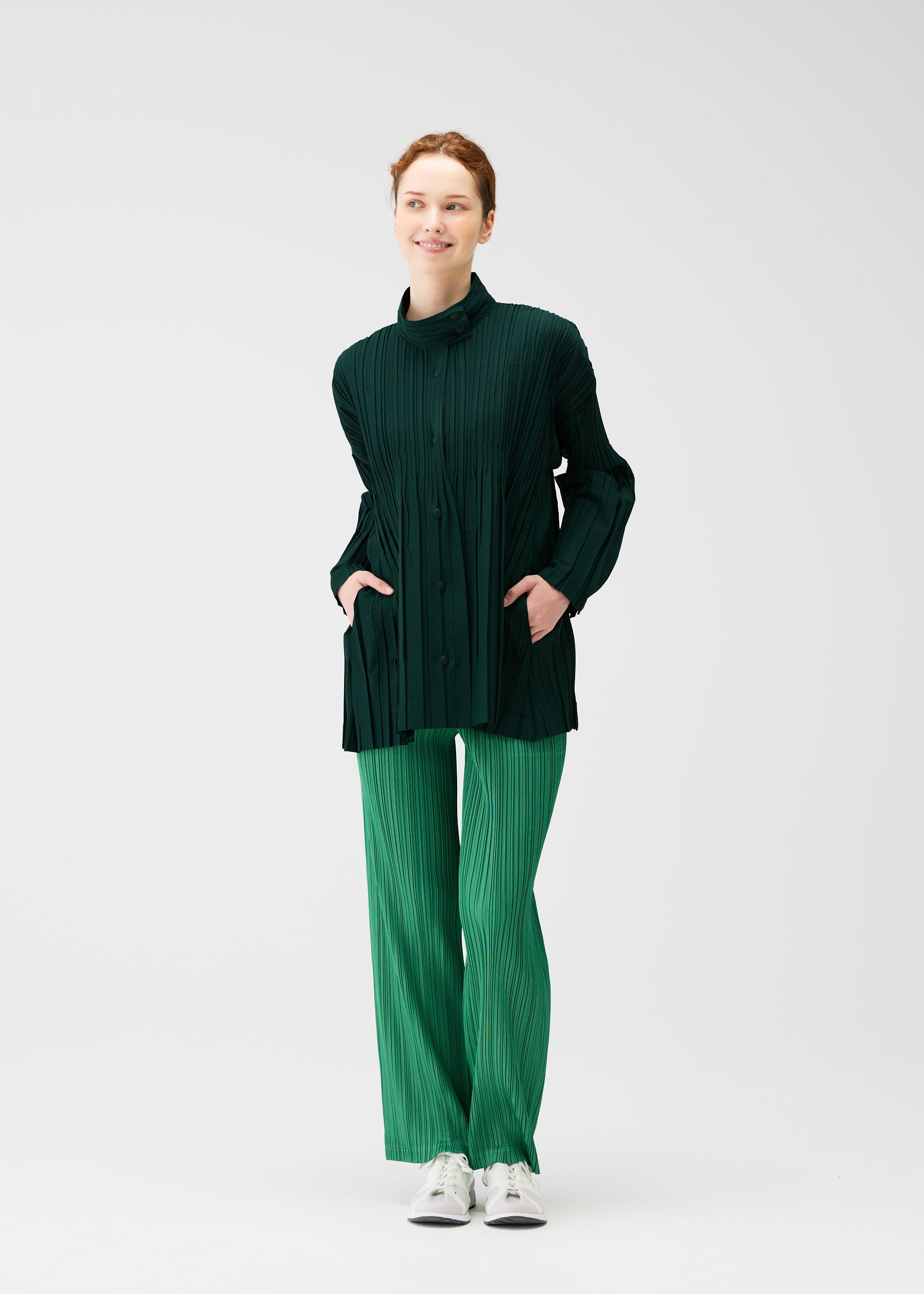 A model wears the PLEATS PLEASE ISSEY MIYAKE FLOAT COAT cardigan.