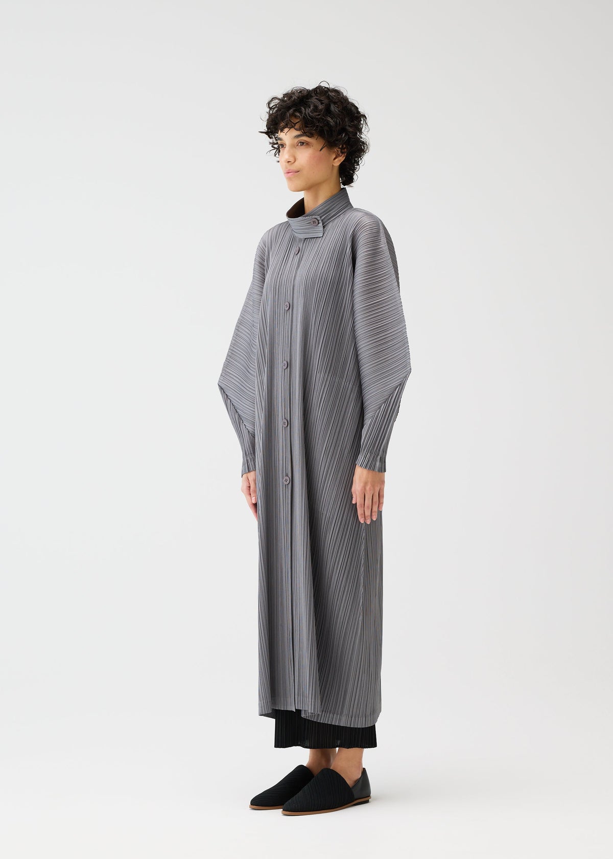 A model wears the PLEATS PLEASE ISSEY MIYAKE SKYLINE clothing.