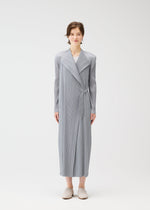 A model wears the PLEATS PLEASE ISSEY MIYAKE FACADE coat.