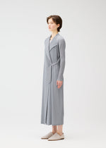 A model wears the PLEATS PLEASE ISSEY MIYAKE FACADE coat.