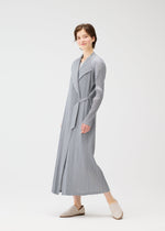 A model wears the PLEATS PLEASE ISSEY MIYAKE FACADE coat.