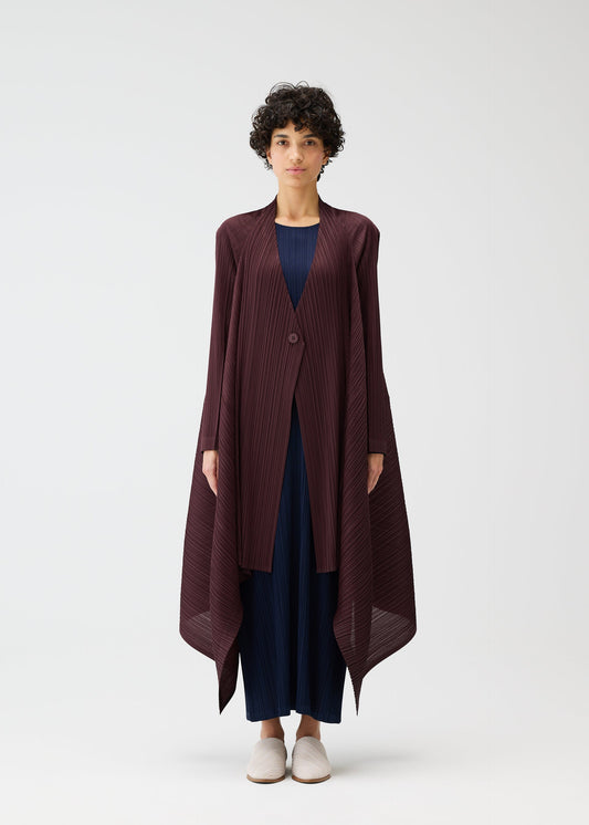 A model wears the PLEATS PLEASE ISSEY MIYAKE CITY FRAME coat.