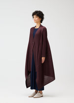 A model wears the PLEATS PLEASE ISSEY MIYAKE CITY FRAME coat.