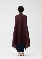 A model wears the PLEATS PLEASE ISSEY MIYAKE CITY FRAME coat.