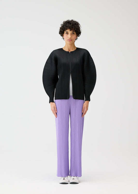 A model wears the PLEATS PLEASE ISSEY MIYAKE MONTHLY COLORS APRIL jacket.