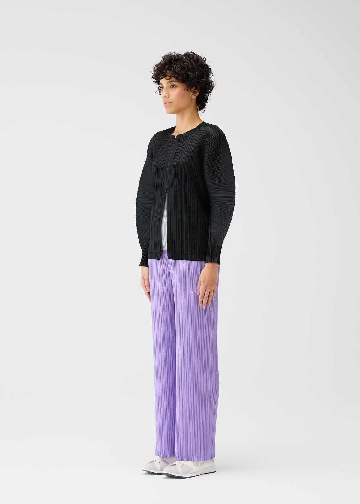 A model wears the PLEATS PLEASE ISSEY MIYAKE MONTHLY COLORS APRIL jacket.