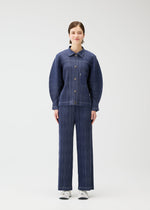 A model wears the PLEATS PLEASE ISSEY MIYAKE COTTON DENIM jacket.