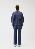 A model wears the PLEATS PLEASE ISSEY MIYAKE COTTON DENIM jacket.