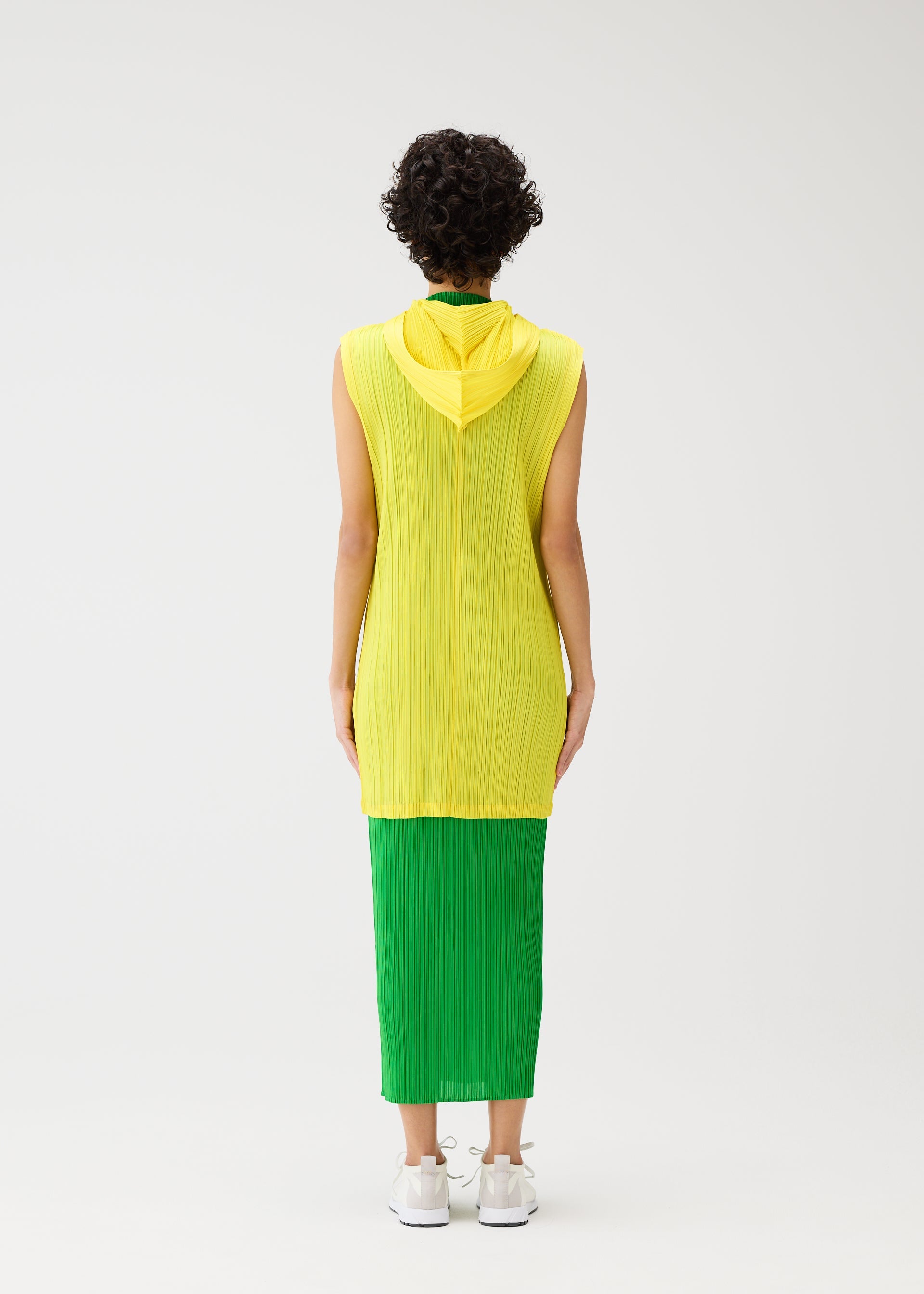 A model wears the PLEATS PLEASE ISSEY MIYAKE MONTHLY COLORS APRIL vest.