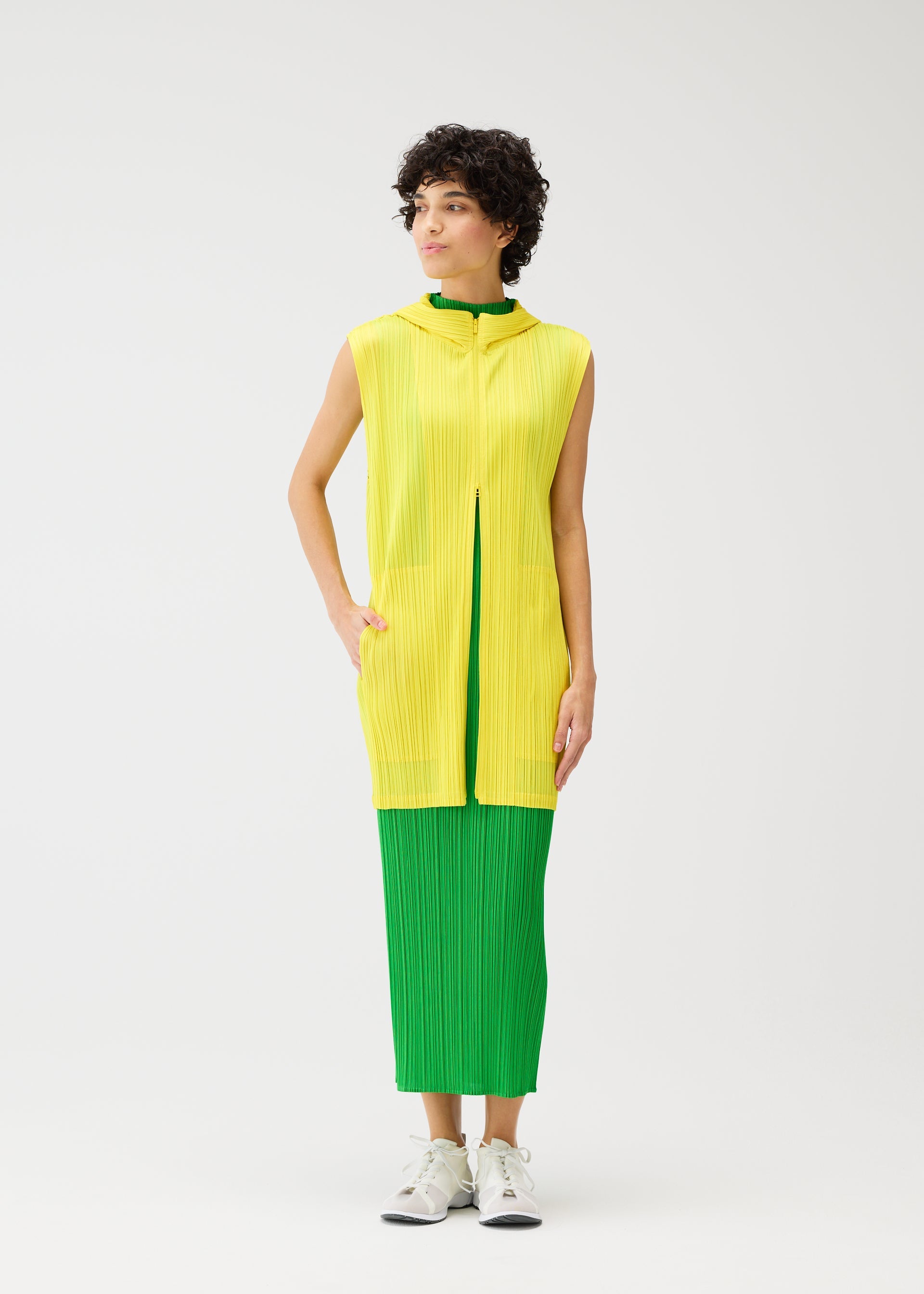 A model wears the PLEATS PLEASE ISSEY MIYAKE MONTHLY COLORS APRIL vest.