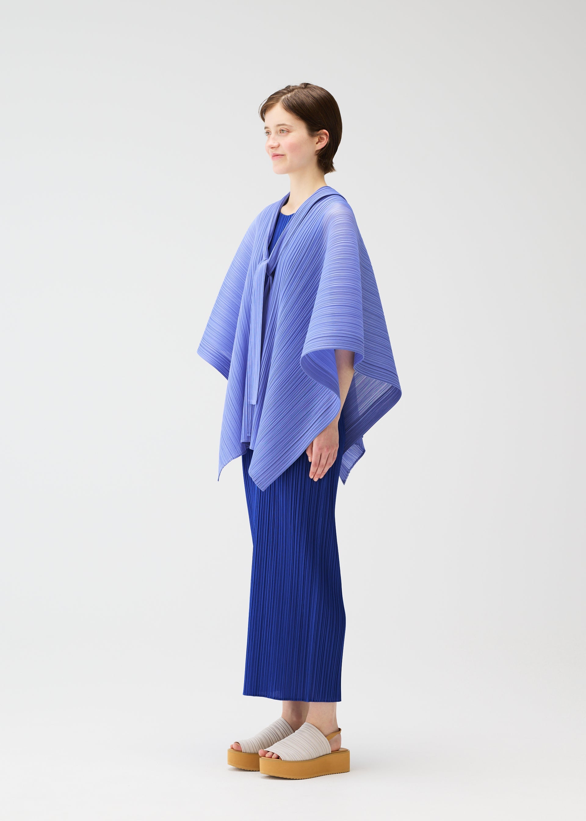 A model wears the PLEATS PLEASE ISSEY MIYAKE LUCID PLEATS vest.