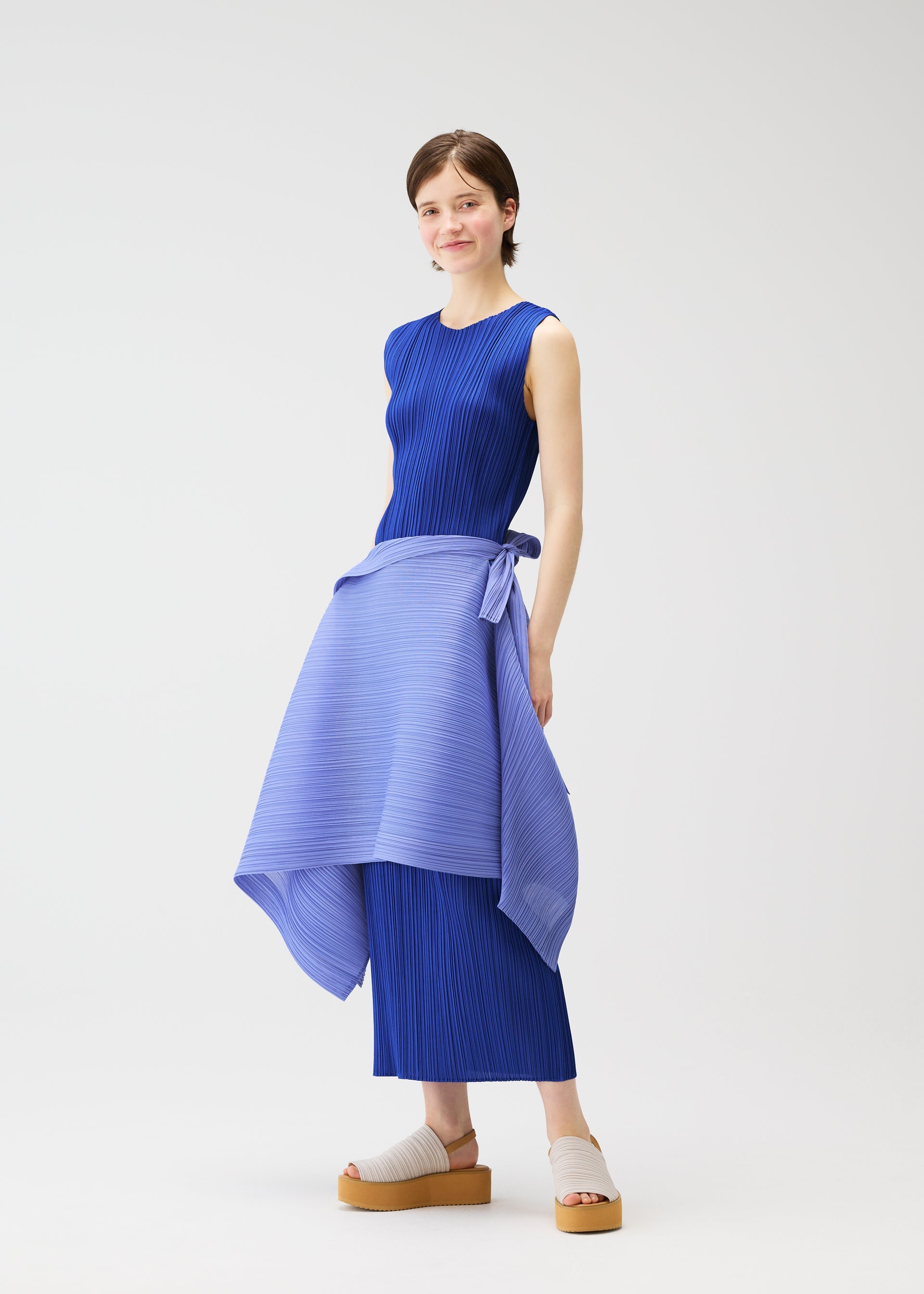 A model wears the PLEATS PLEASE ISSEY MIYAKE LUCID PLEATS vest.