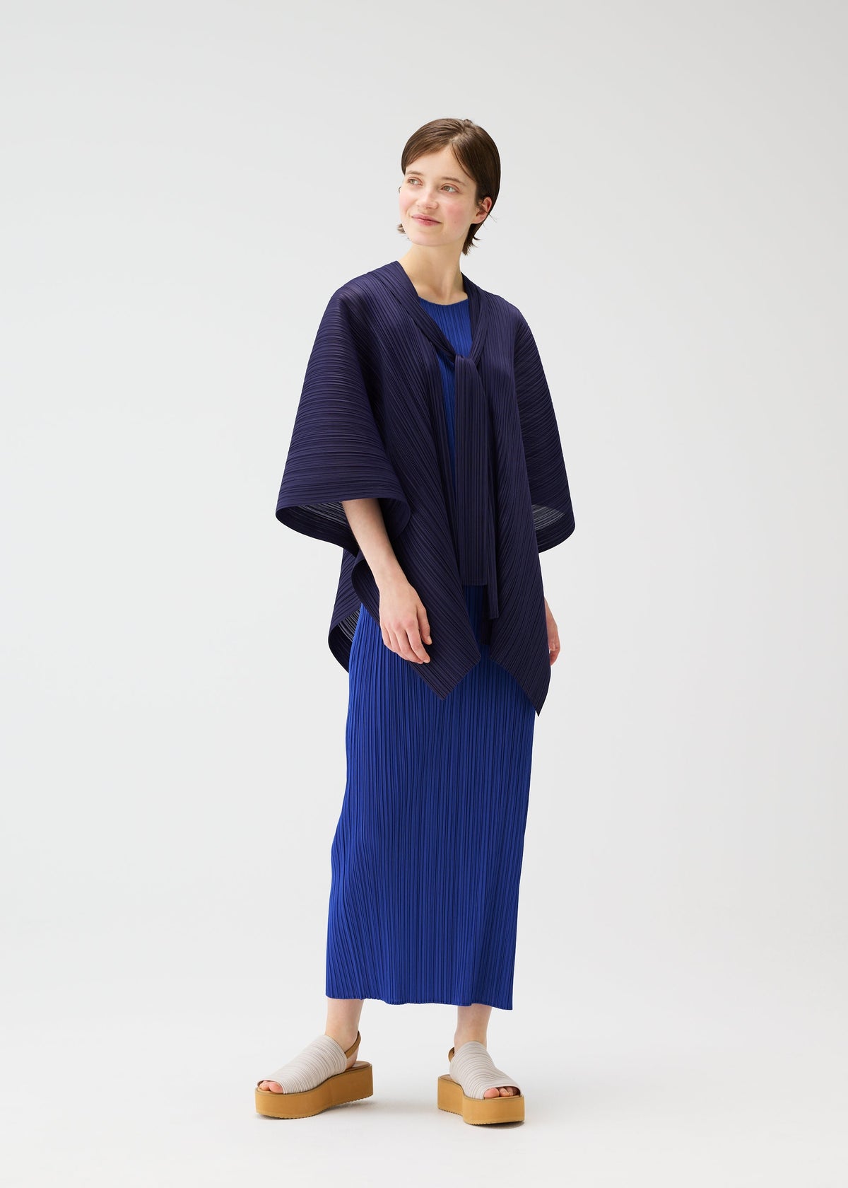 A model wears the PLEATS PLEASE ISSEY MIYAKE LUCID PLEATS vest.