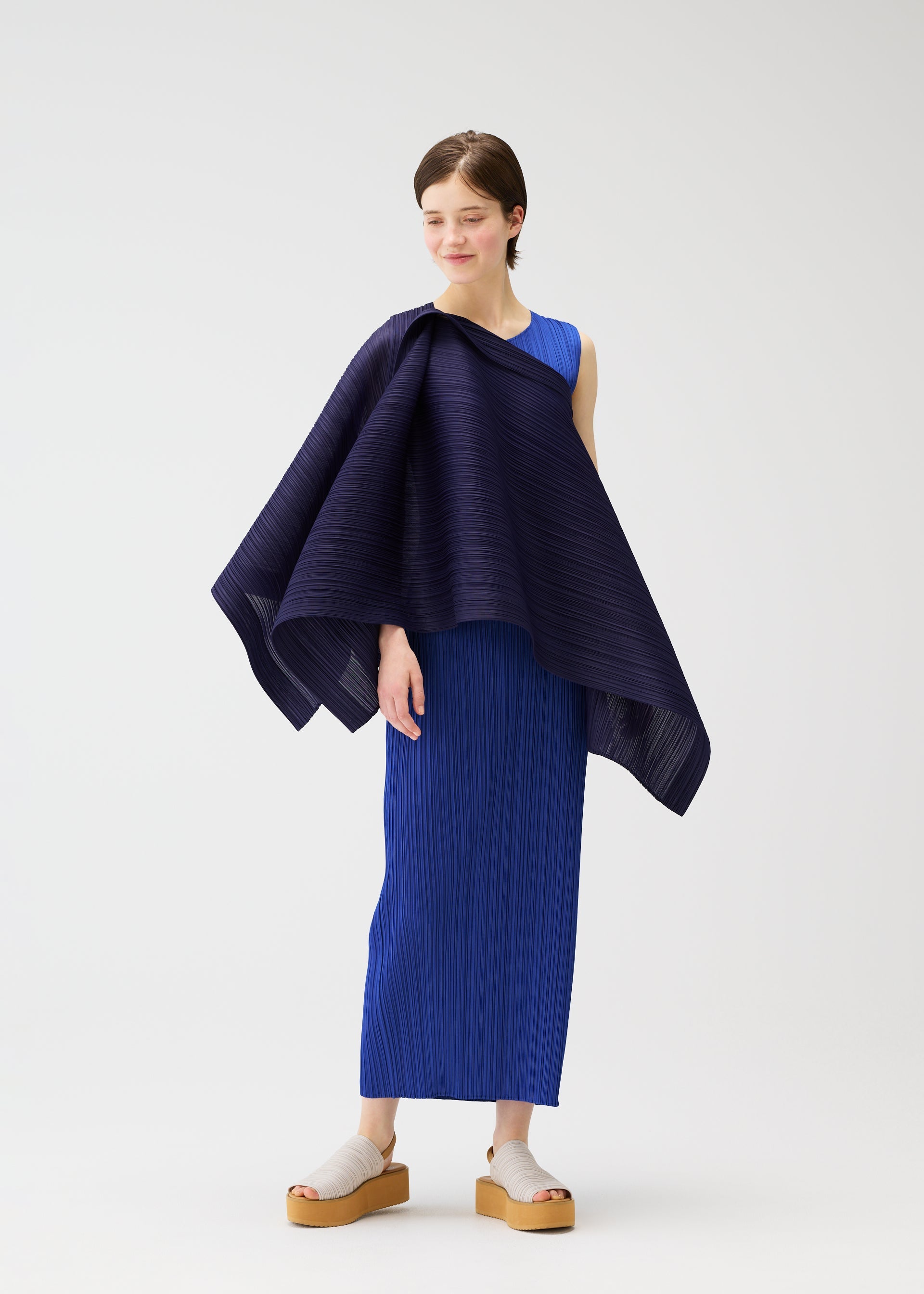 A model wears the PLEATS PLEASE ISSEY MIYAKE LUCID PLEATS vest.