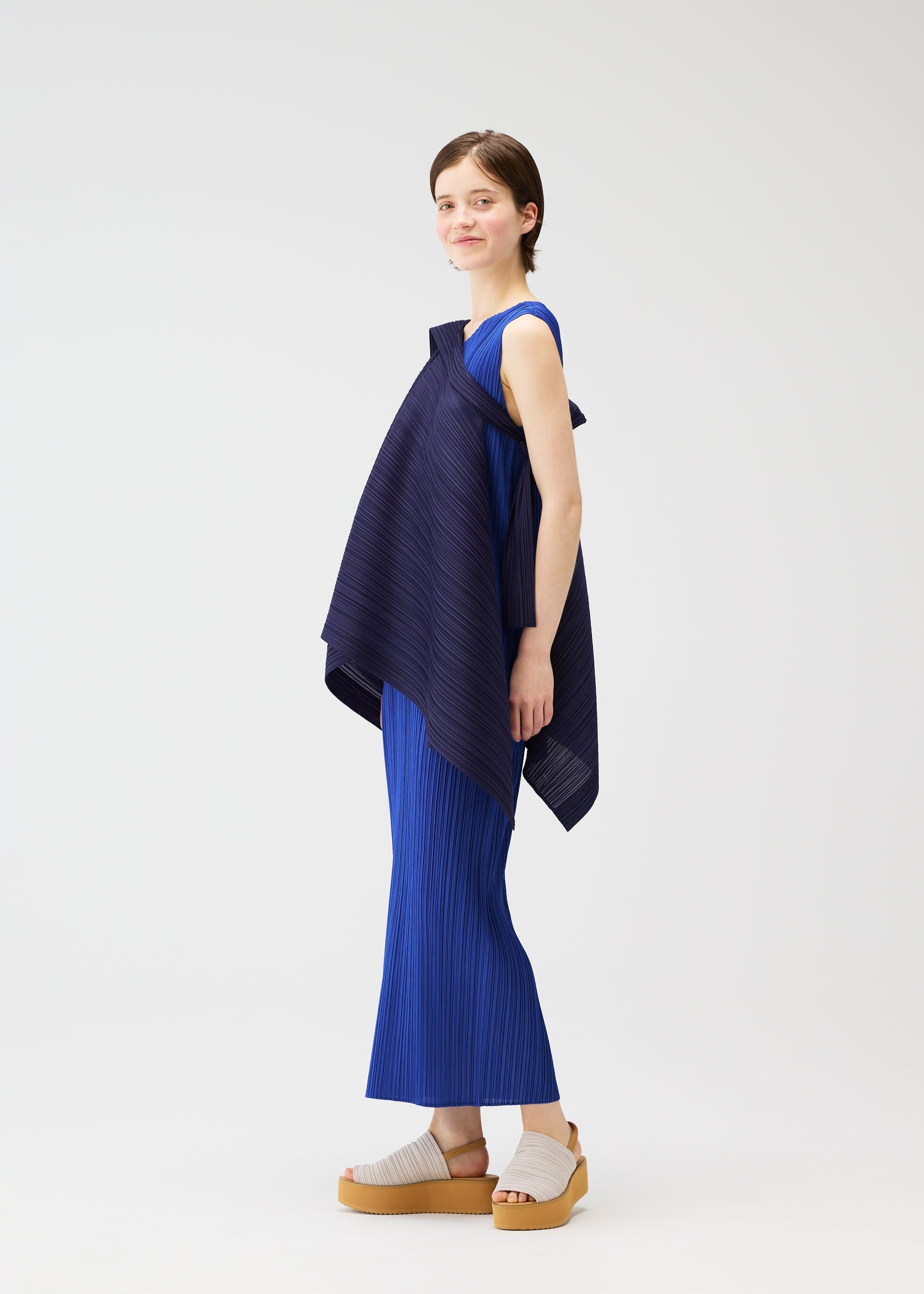 A model wears the PLEATS PLEASE ISSEY MIYAKE LUCID PLEATS vest.