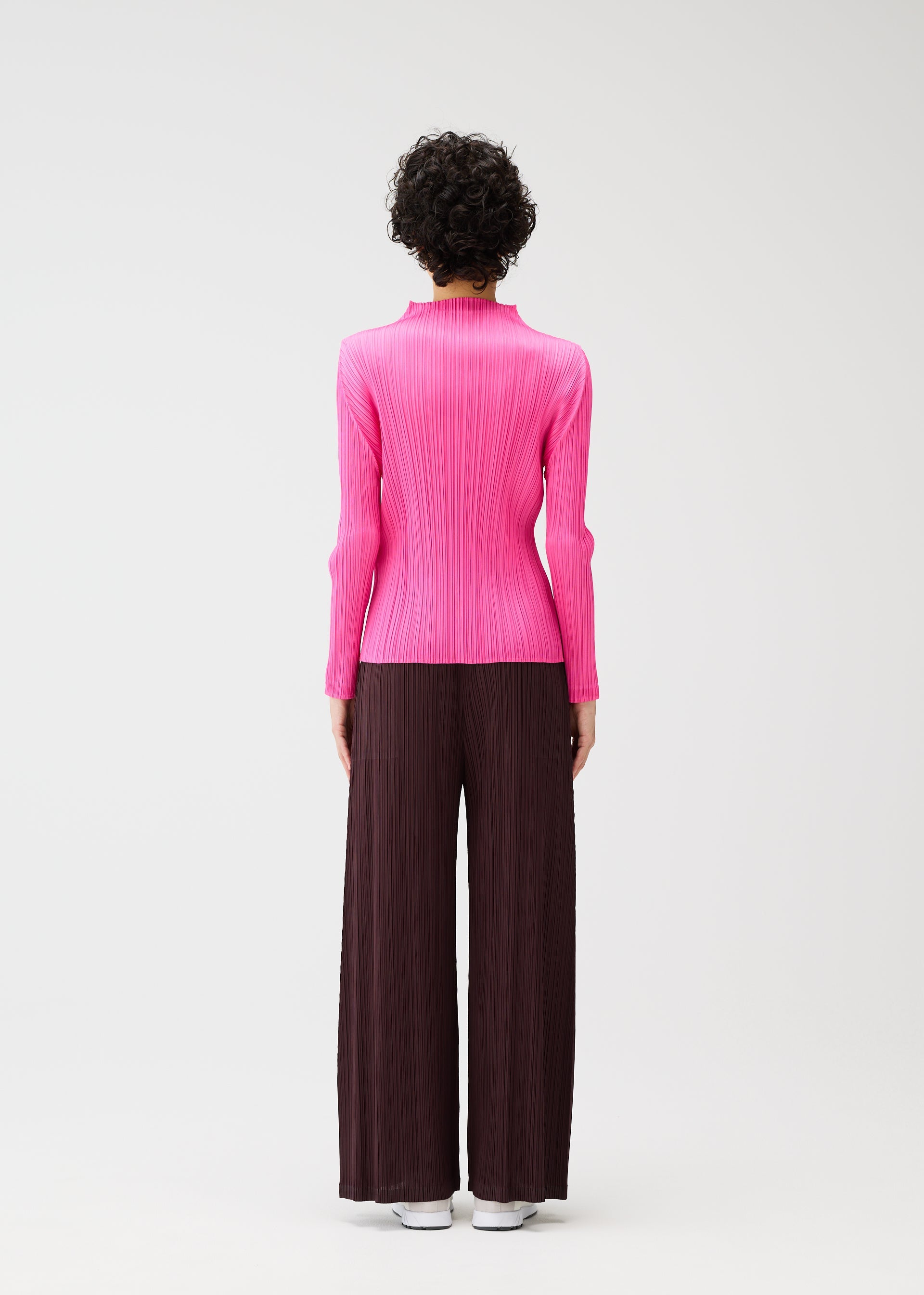 A model wears the PLEATS PLEASE ISSEY MIYAKE MONTHLY COLORS JANUARY clothing.