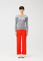 A model wears the PLEATS PLEASE ISSEY MIYAKE MONTHLY COLORS FEBRUARY trousers.