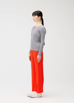 A model wears the PLEATS PLEASE ISSEY MIYAKE MONTHLY COLORS FEBRUARY trousers.