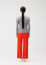 A model wears the PLEATS PLEASE ISSEY MIYAKE MONTHLY COLORS FEBRUARY trousers.