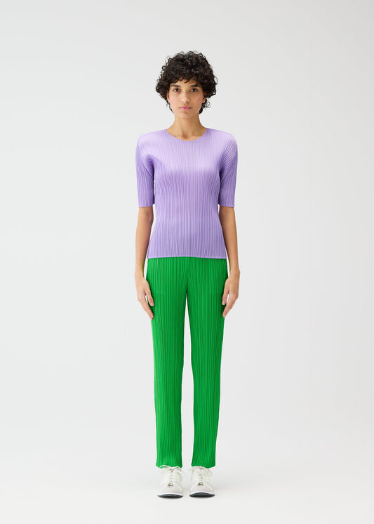 A model wears the PLEATS PLEASE ISSEY MIYAKE MONTHLY COLORS APRIL trousers.